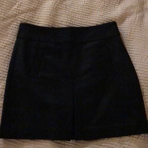 Black mini with pockets and zipper in back